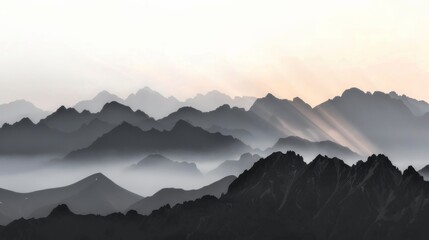 Obraz premium A breathtaking panoramic view of a mountain range at dawn with the first light of day casting a golden glow over the peaks and valleys