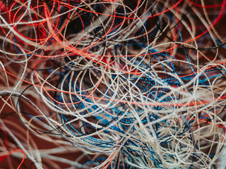 Chaotically tangled threads. Embroidery threads randomly woven. Huge knot. Extreme macro. Beautiful...