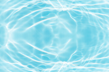 Blue water with ripples on the surface. Defocus blurred transparent blue colored clear calm water surface texture with splashes and bubbles. Water waves with shining pattern texture background.