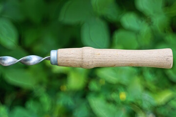 one gray long wooden handle on an skewer on the street