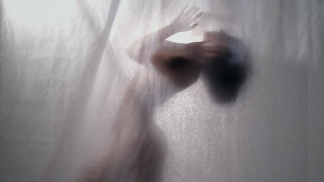Contemporary Dance: Fluid Silhouette Behind Sheer Veil