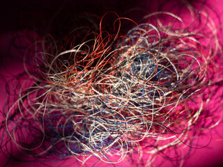 Chaotically tangled threads. Embroidery threads randomly woven. Huge knot. Extreme macro. Beautiful...