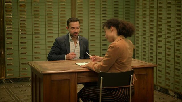 Business discussion in vintage archive room among collaborating businesspeople on a corporate deal