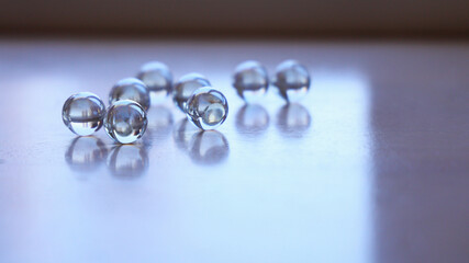 Shadow of a glass marble transmitting light on a window sill