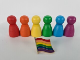 Colorful Wooden Figures With a Rainbow Pride Flag