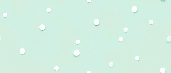 A pastel mint green background with delicate polka dots
