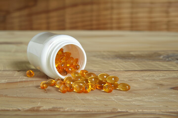 Vitamin soft gels out of white plastic bottle on wooden table. Generative AI