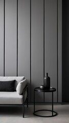 Grey wall panels and a black side table in minimalistic interior design composition.

