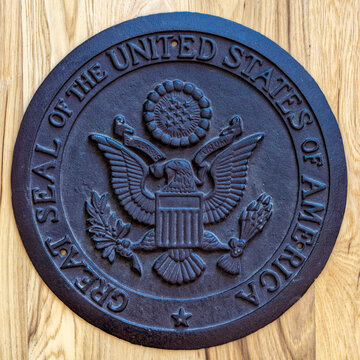 Idaho, USA - May 16, 2024: An iron replica of the Great Seal of the United States of America on a wood floor