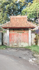 Straight angle view of a vintage-styled wooden entrance gate to a house
