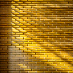 Background for product presentation. Yellow brick wall with shadows from window, sun rays through blinds, for architectural and interior design concepts.  Copy space