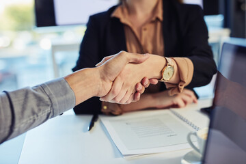 Obraz premium Handshake, partnership and business people in office for corporate merger, agreement or onboarding. Meeting, finance offer and banker shaking hands with client for b2b company deal in collaboration.