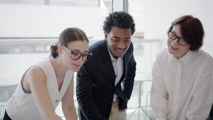 In a modern office environment, young professionals collaborate with teamwork, brainstorming, leadership, and creative ideas to boost synergy and create a positive work atmosphere