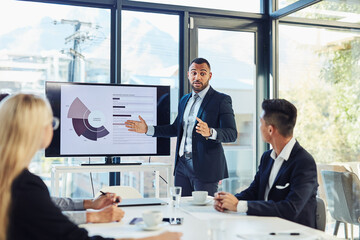 Meeting, presentation and business man with statistics for financial profit, infographics or growth charts. Office, colleagues and person by monitor for marketing data, budget review or information