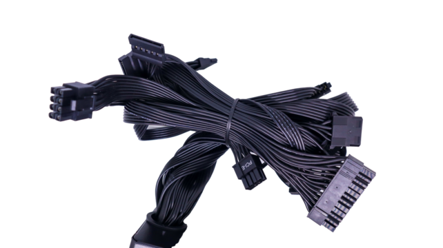 A tangled bundle of black PC cables with connectors isolated on a white background. Black PC Cables with Connectors.