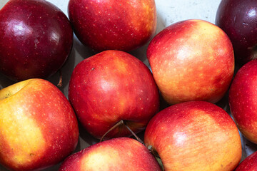 Red and yellow apples for sale on a market or supermarket stall.
