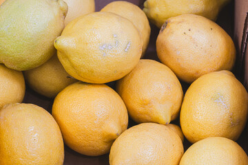 Yellow lemons in very close-up on a market stall