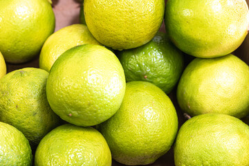 green lemons in very close-up on a market stall