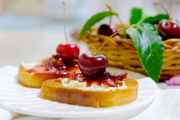 Bruschetta with cherry jam. Appetizer with ricotta cheese, cream cheese, berry jam. Toast, sweet snack for breakfast
