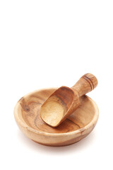 An empty wooden bowl and a wooden scoop are isolated on a white background.