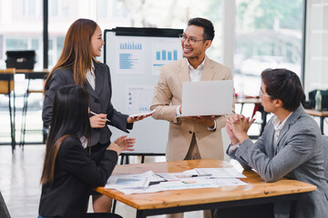 Professional diverse business team presenting and discussing data charts and graphs during meeting in modern office.