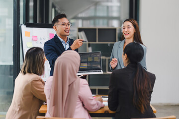 Professional diverse business team presenting and discussing data charts and graphs during meeting in modern office.