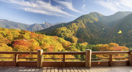 Fototapeta premium 木造のテラス・縁側から望む秋の美しい紅葉の山々と森林の風景背景素材 風に舞い散る色づいた木の葉 日本の季節・旅行・アウトドア・観光のイメージ 秋の空と雲雄大な風景