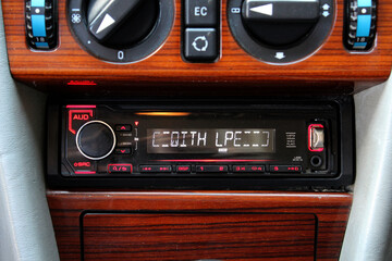 Classic car dashboard and wood panel. Old classic car radio. Classic Digital Media Receiver. Classic car wood panel. Old car wood interior.