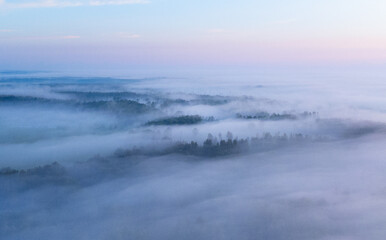 A beautiful misty morning aerophotography of rural landscape in Latvia. Natural summer scenery in Northern Europe.