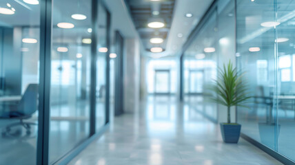 Modern office space: a bright corridor with glass partitions and minimalist design. Bright lighting and a plant create a professional atmosphere. The blurriness of the image emphasizes the dynamics.