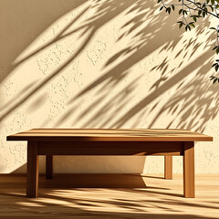 Empty wood table top on beige wall texture with tree leaves shadow background