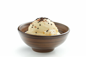 Scoop of vanilla ice cream with chocolate sprinkles resting in bowl