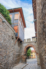 View of a narrow street featuring and antique arch in the Old Town district in Plovdiv City, Bulgaria
