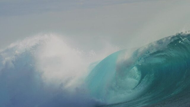 Churning whitewash sprays mist high into air as powerful wave crashes, Cloudbreak Fiji
