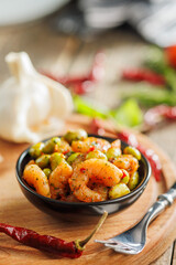 Fresh salad with shrimps and edamame soybeans in bowl on wooden table.