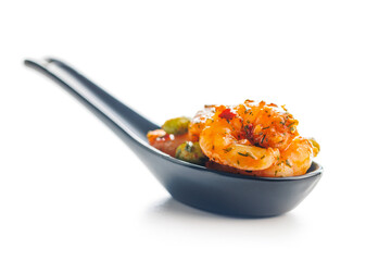 Fresh salad with shrimps and edamame soybeans in spoon isolated on white background.