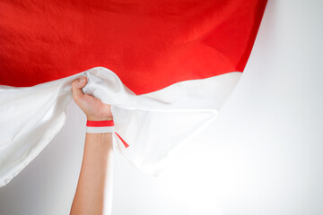 Excited men holding flags celebrating Indonesia's independence day