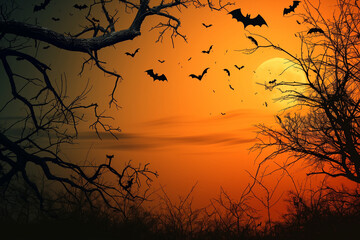 silhouette of spooky, leafless trees with bats flying at sunset