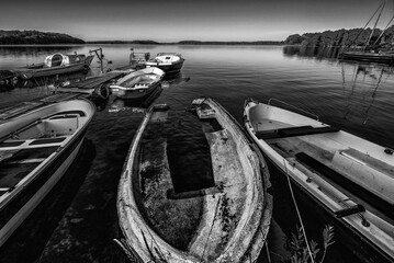 LANDSCAPE BY THE LAKE - Small old rowing boats on the lake
