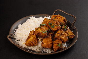 Chicken Bhuna Curry is a Spicy and Flavorful Dish from Indian Cuisine, Served with Rice. 