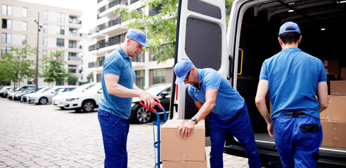 Efficient supply chain management in action: movers unloading cardboard boxes
