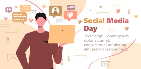  Social Media Day. Young modern man or student in casual clothes with a laptop in her hand. Businessman typing, surfing internet, using technology. Online life and communication concept. 