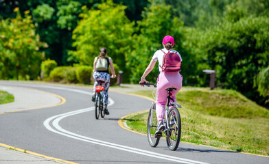 Naklejka premium Cyclist ride on the bike path in the city Park 