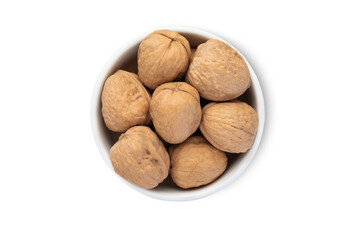 Ceramic bowl with organic walnut nuts with shell isolated on white background.Top view.