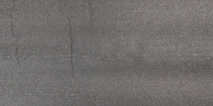 view from above on texture of asphalt road with cracks