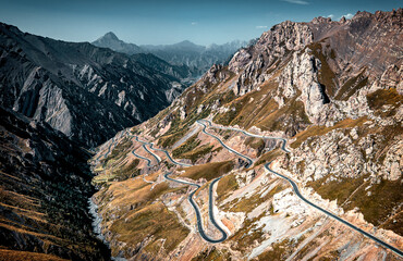Aerial view of the switchback and winding road on the mountain ridge near Tieli Maiti Daban section...