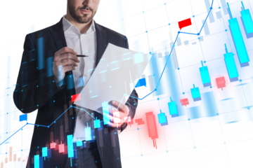 A man in a suit interacting with a transparent futuristic interface showing financial charts, overlaid on a white background