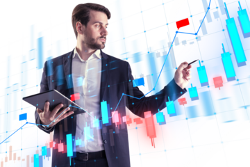 A businessman analyzing digital financial charts, holding a tablet, with a futuristic interface overlay on top
