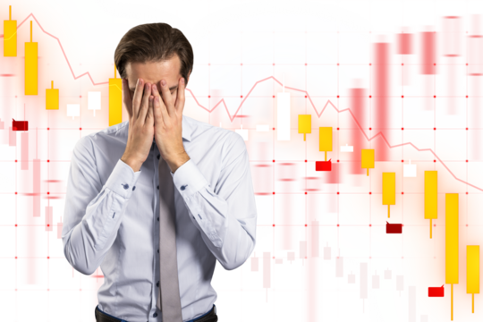 Man with hands on face expressing stress against financial chart backdrop, symbolizing business frustration