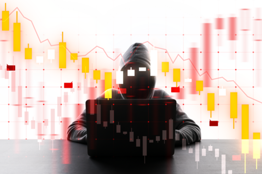 A silhouette of a hooded hacker with a laptop in front of digital financial graphs, depicting cybercrime in finance